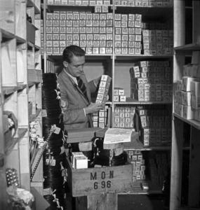 Apprentice checking the stocks at the warehouse, Germany 1940s. Apprentice checking the stocks at the warehouse, Germany 1940s.